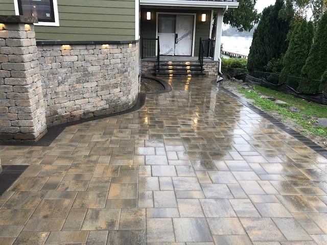 A brick driveway leading to the front door of a house