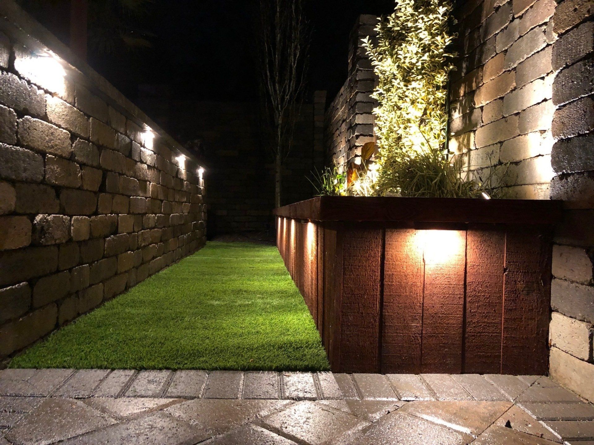 A brick wall with lights on the side of it