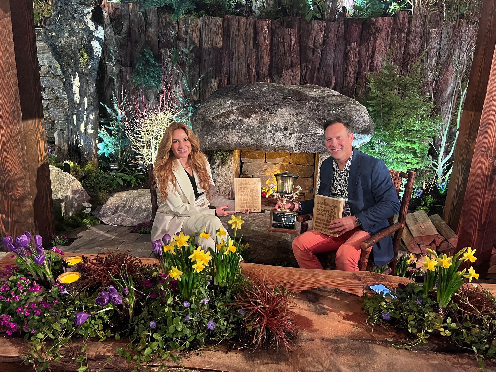 A man and a woman are sitting next to each other in a garden.