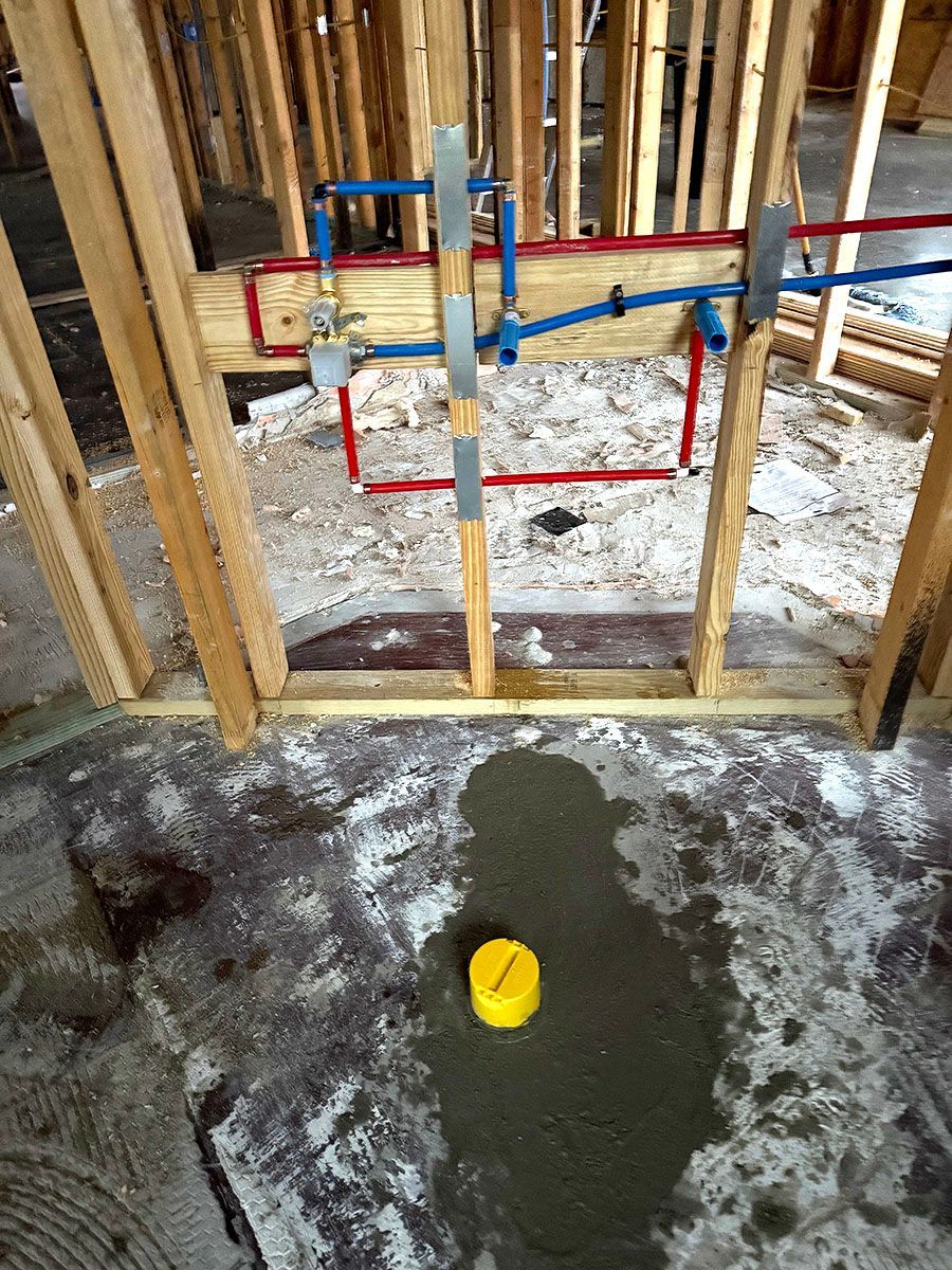 A room under construction with plumbing layout