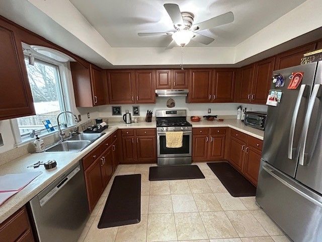 A kitchen with stainless steel appliances and wooden cabinets