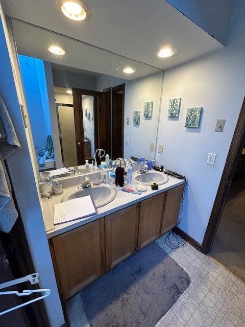 A bathroom with two sinks and a large mirror