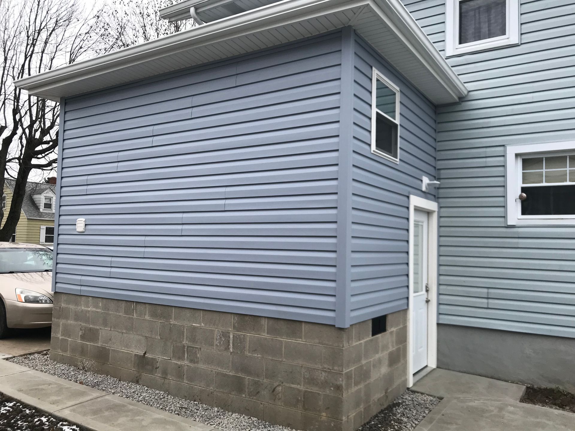 a house with a blue siding and a white door