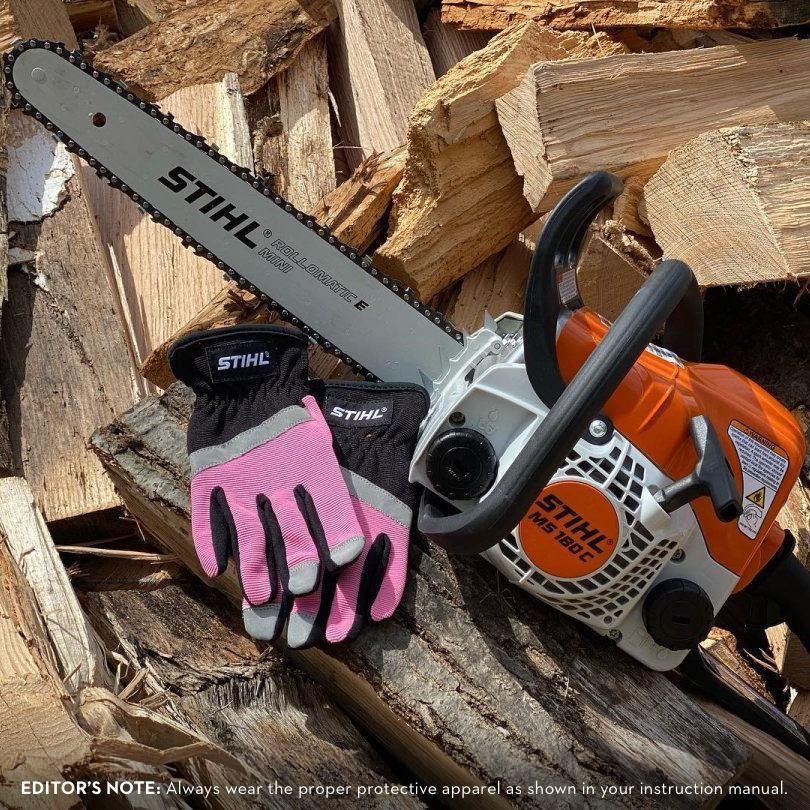Chainsaw, gloves, on wood, with a STIHL logo. The gloves are pink and black.