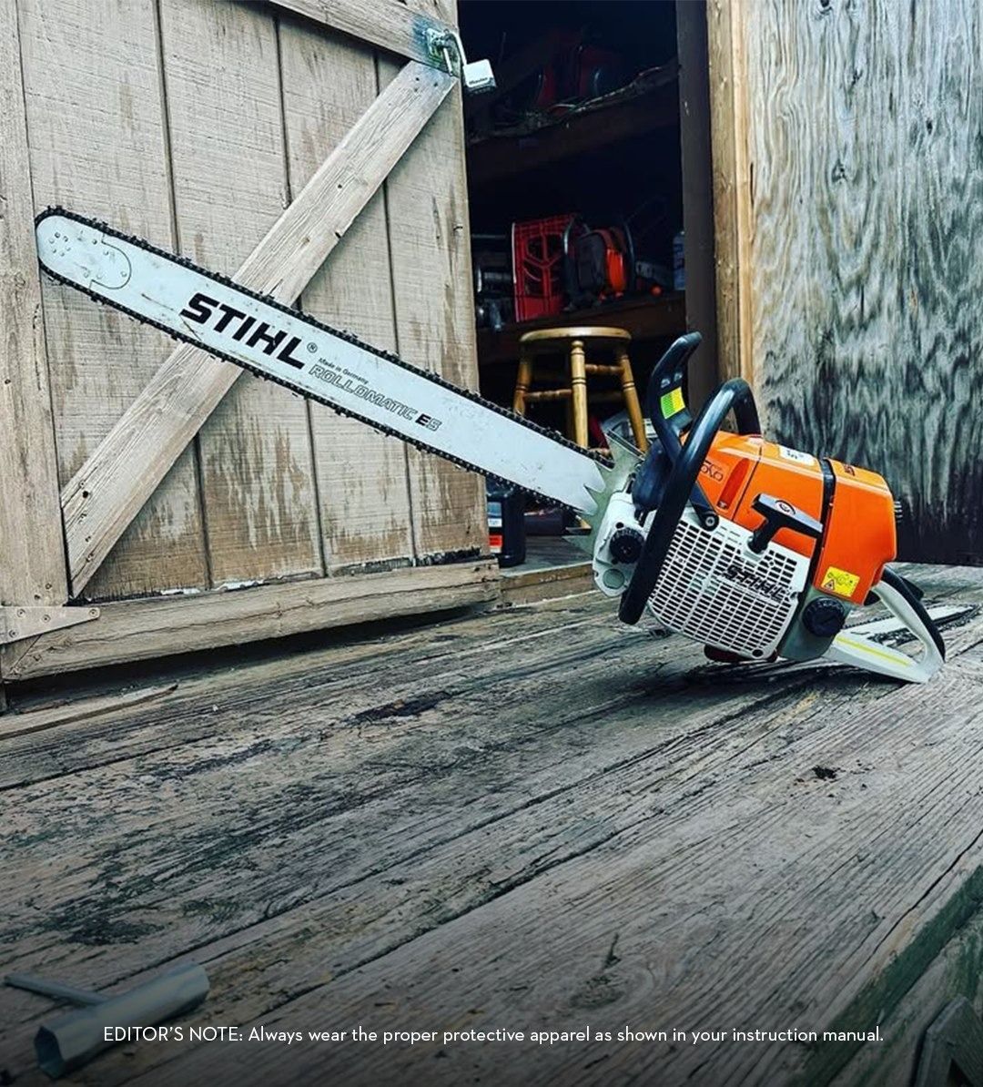 Stihl chainsaw on a wooden surface, leaned against a weathered wooden structure.