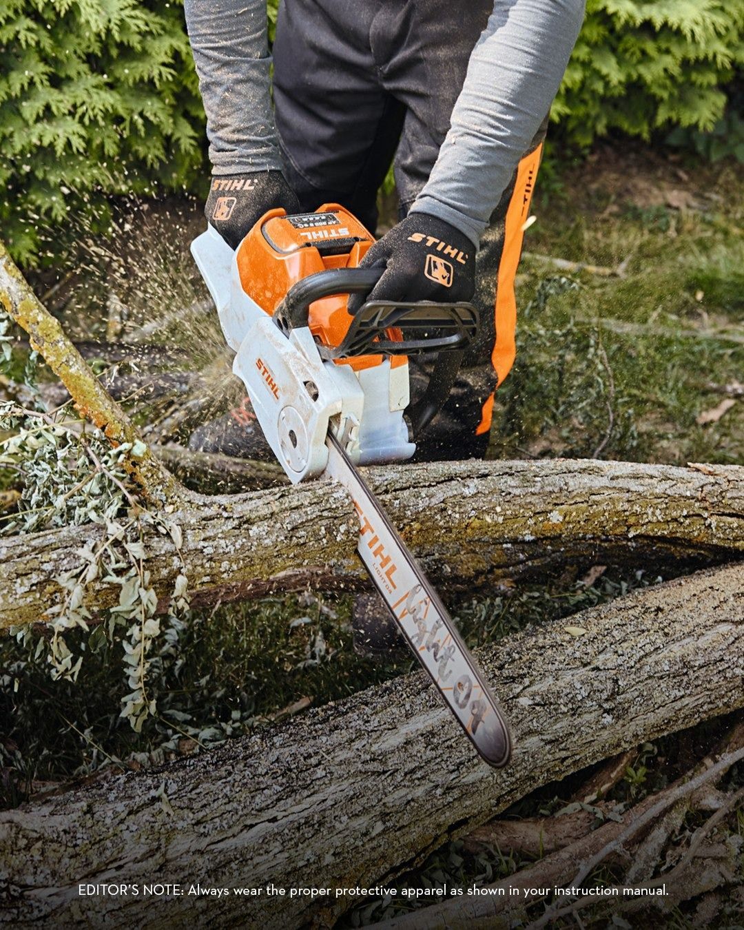 Man using a white and orange chainsaw to cut a log outdoors, wood shavings flying.