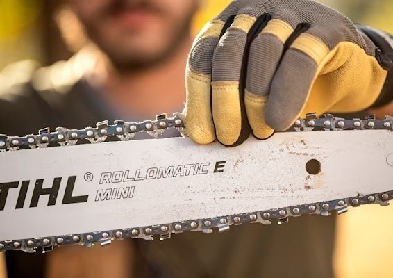 Person holding a chainsaw bar with 