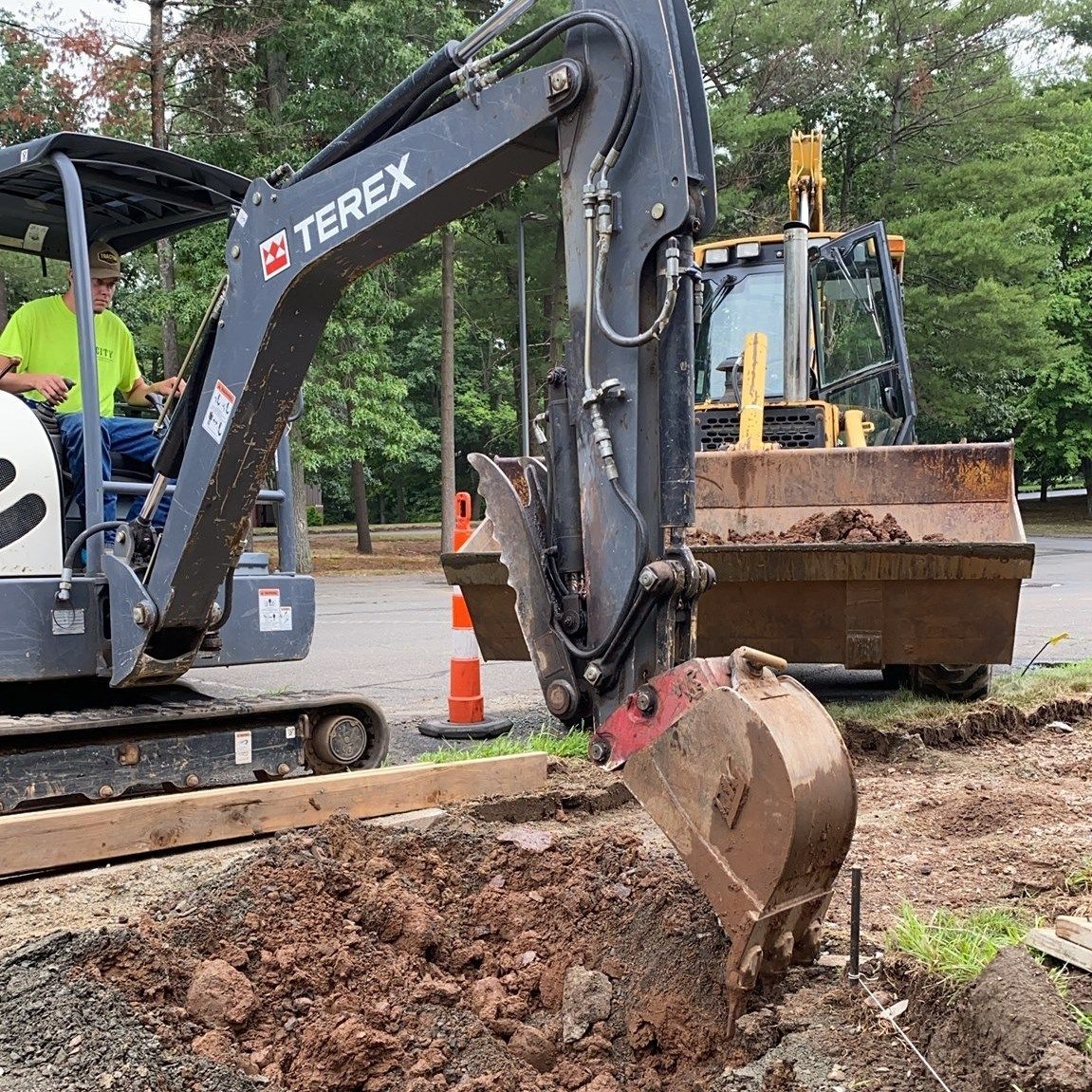 A terex excavator is digging a hole in the ground