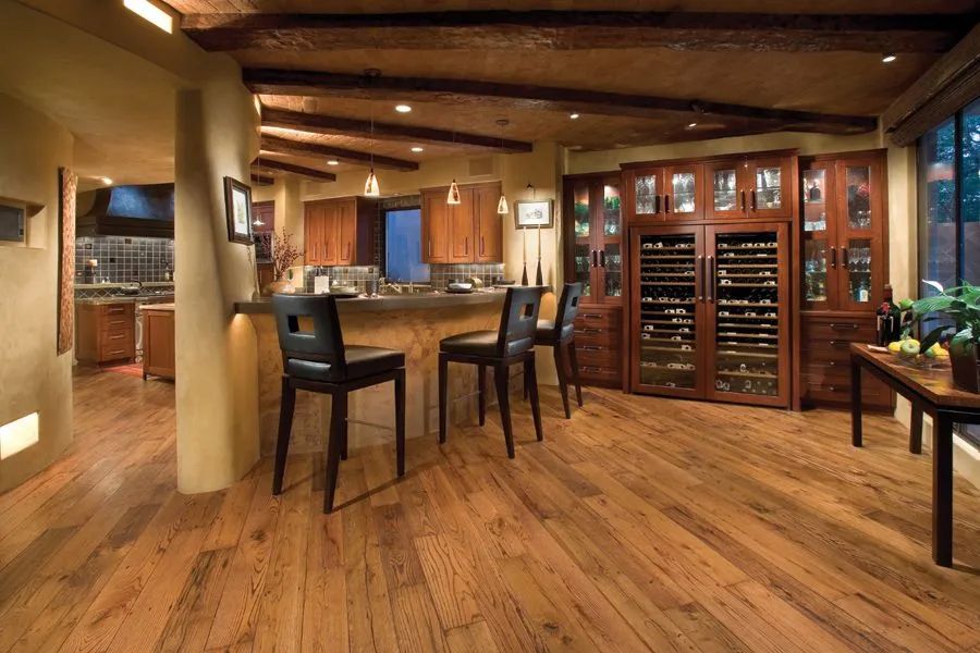 A kitchen with hardwood floors and a wine cooler