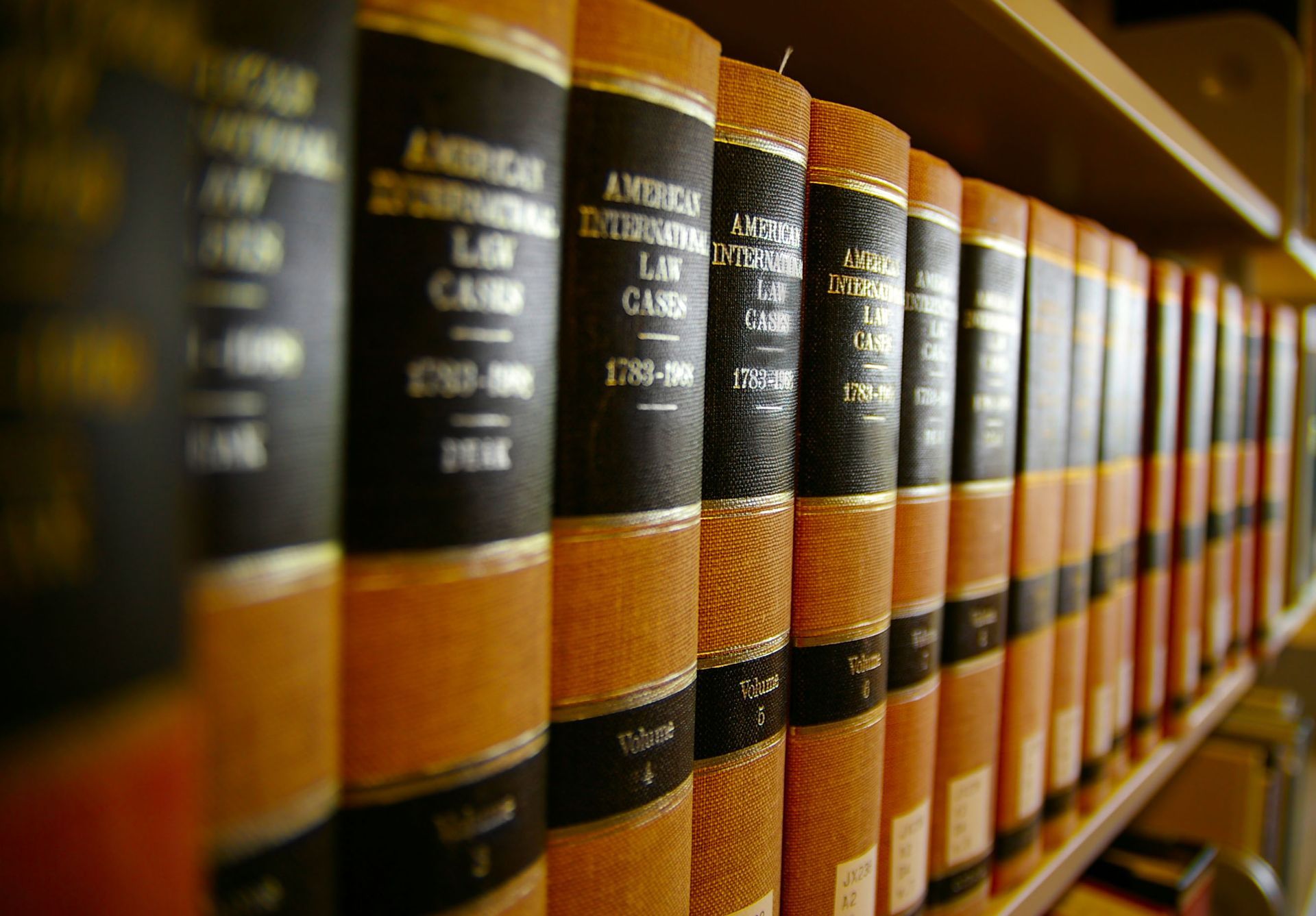 Bookshelves filled with law books. Brown covers, black spines, gold lettering.