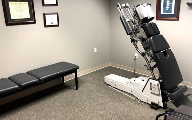 A room with a chair and a bench in it