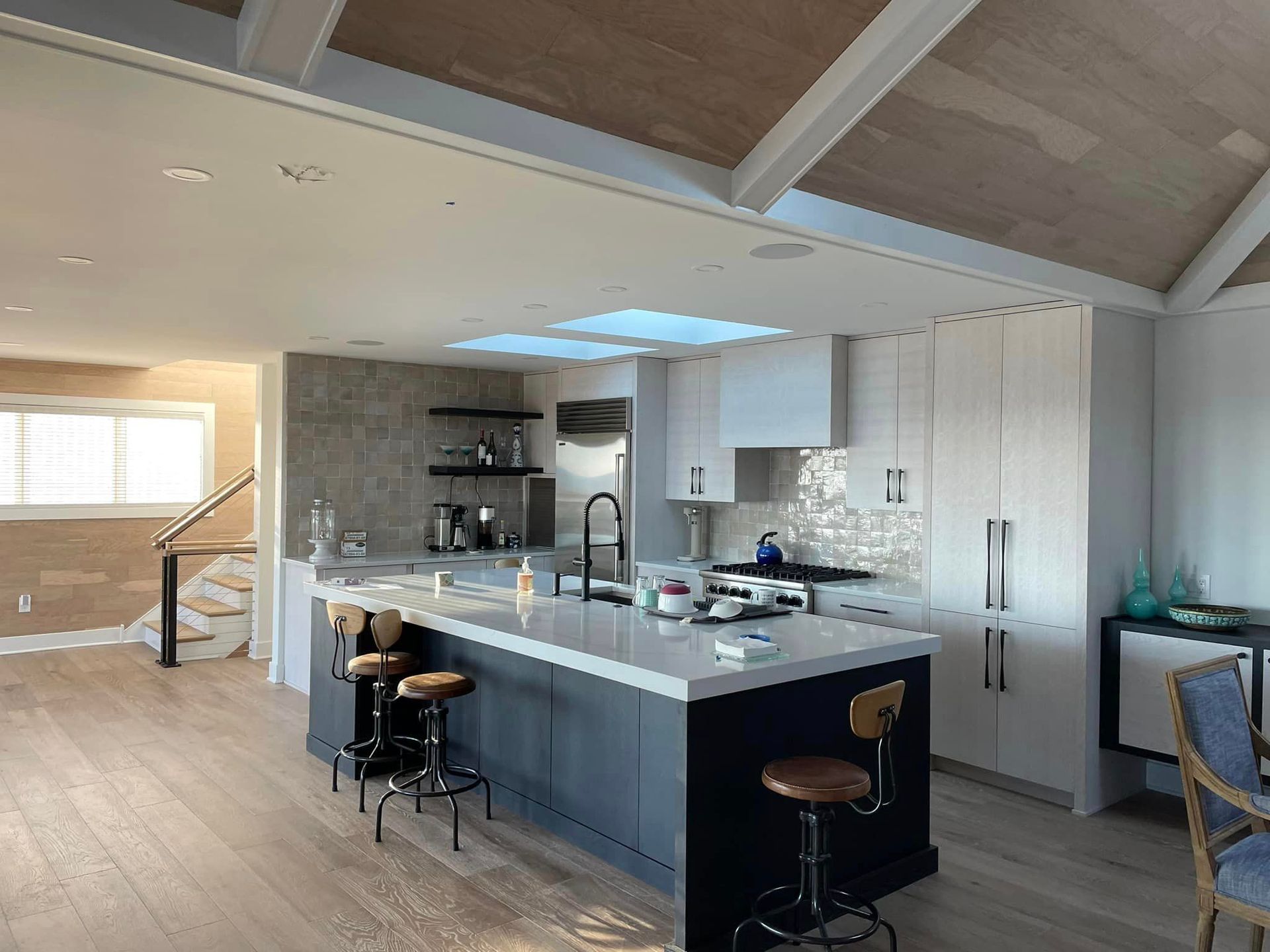 A kitchen with a large island and stools