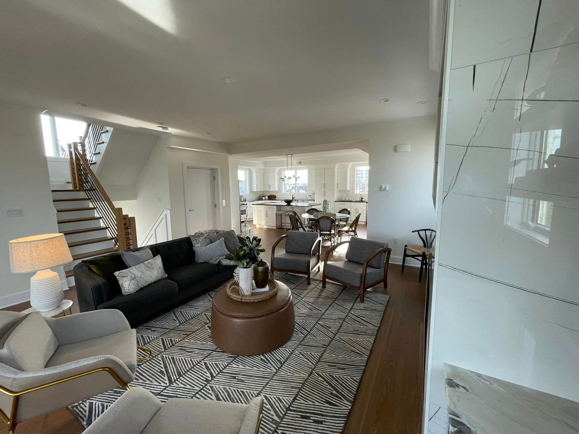 A living room with a couch, chairs, and a coffee table.