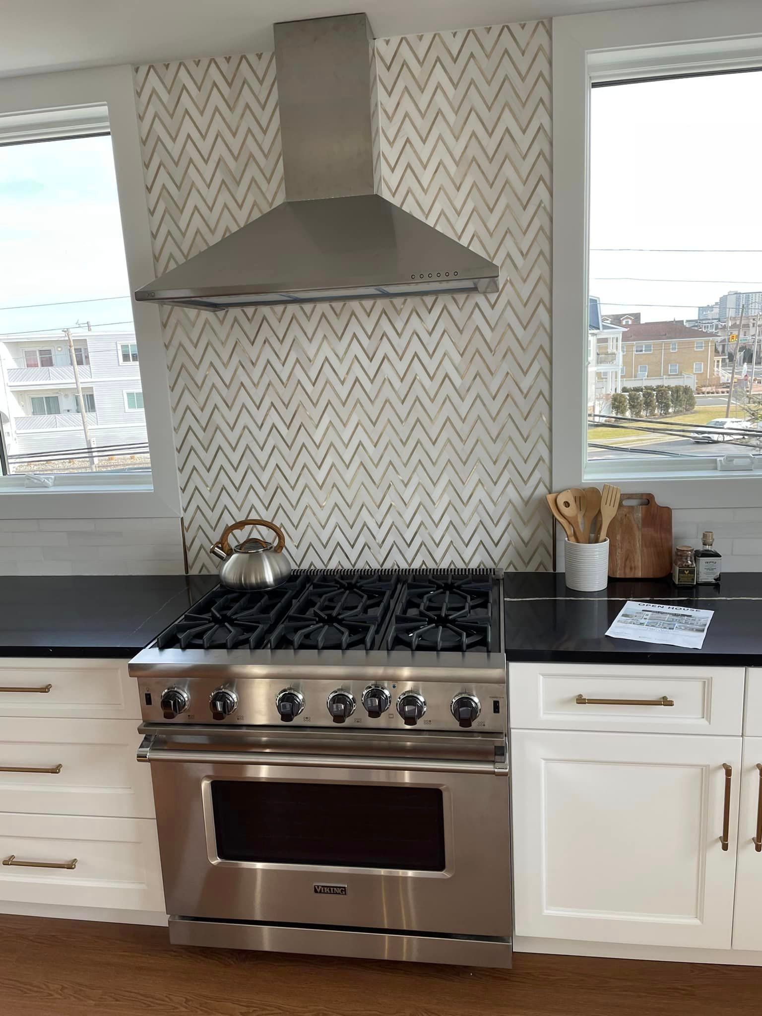 A kitchen with a stove top oven and a window