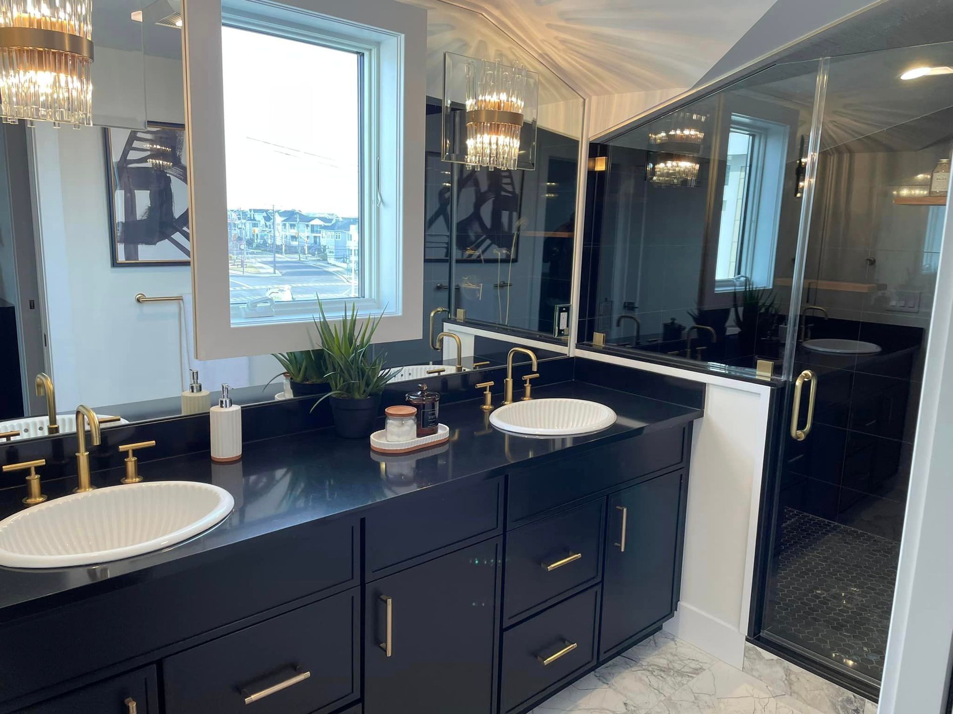 A bathroom with two sinks and a large mirror.