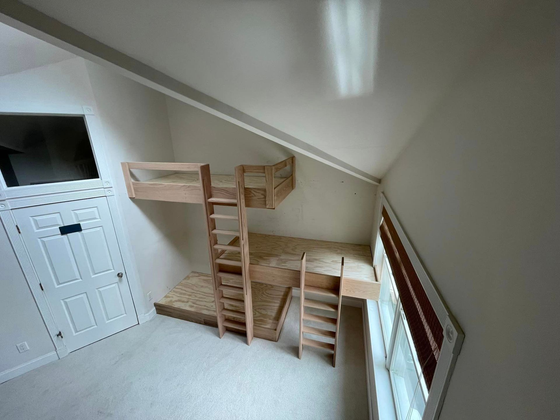 A room with a bunk bed and stairs in it