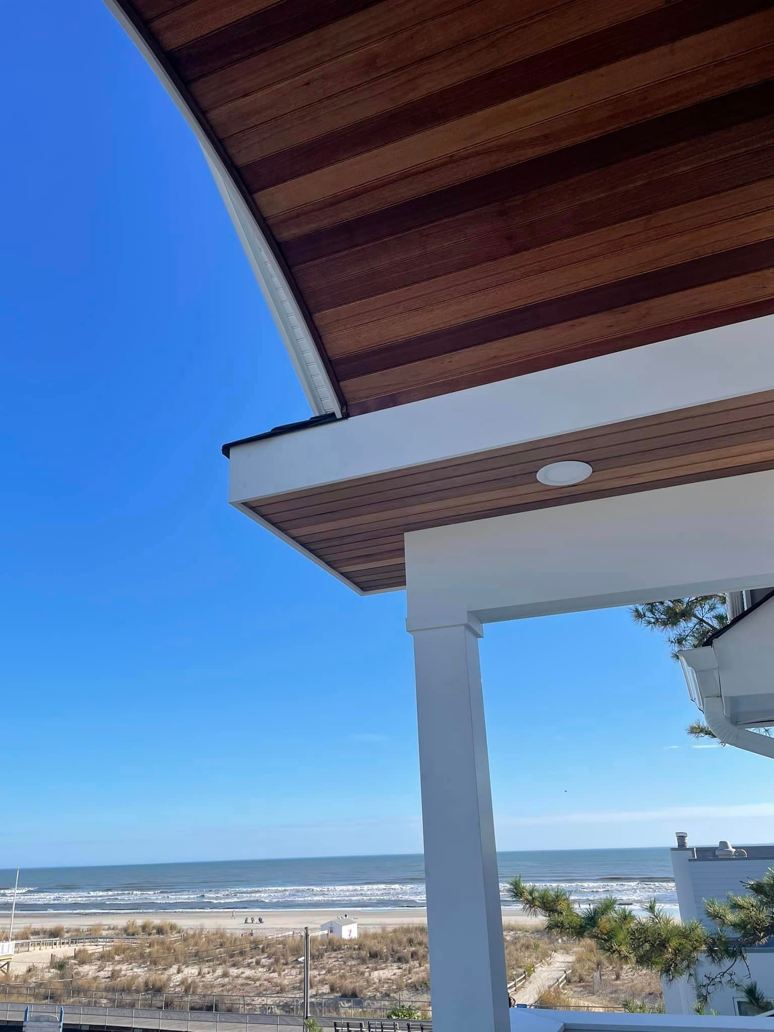 A view of the ocean from a porch of a house.