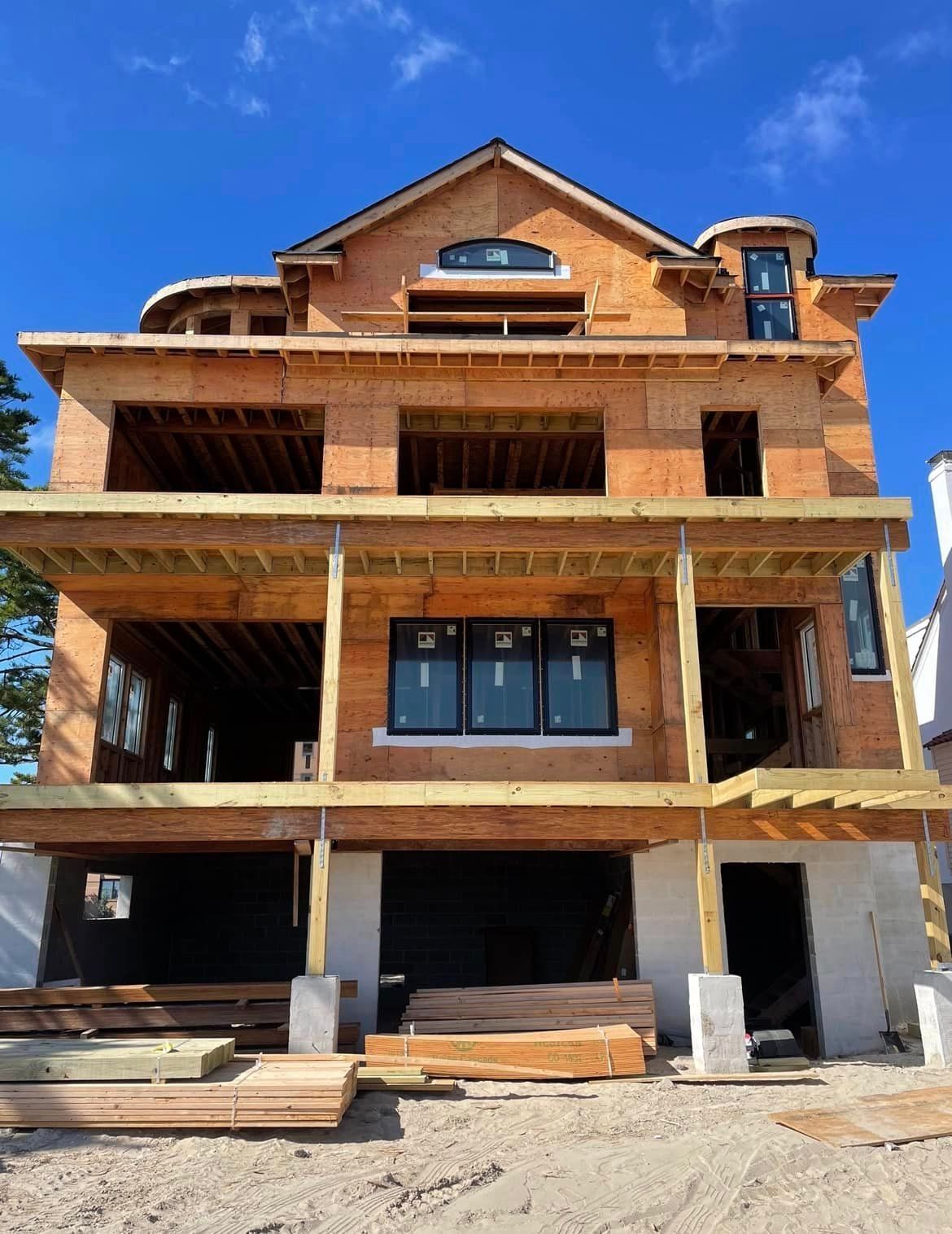 A large house under construction with a lot of windows