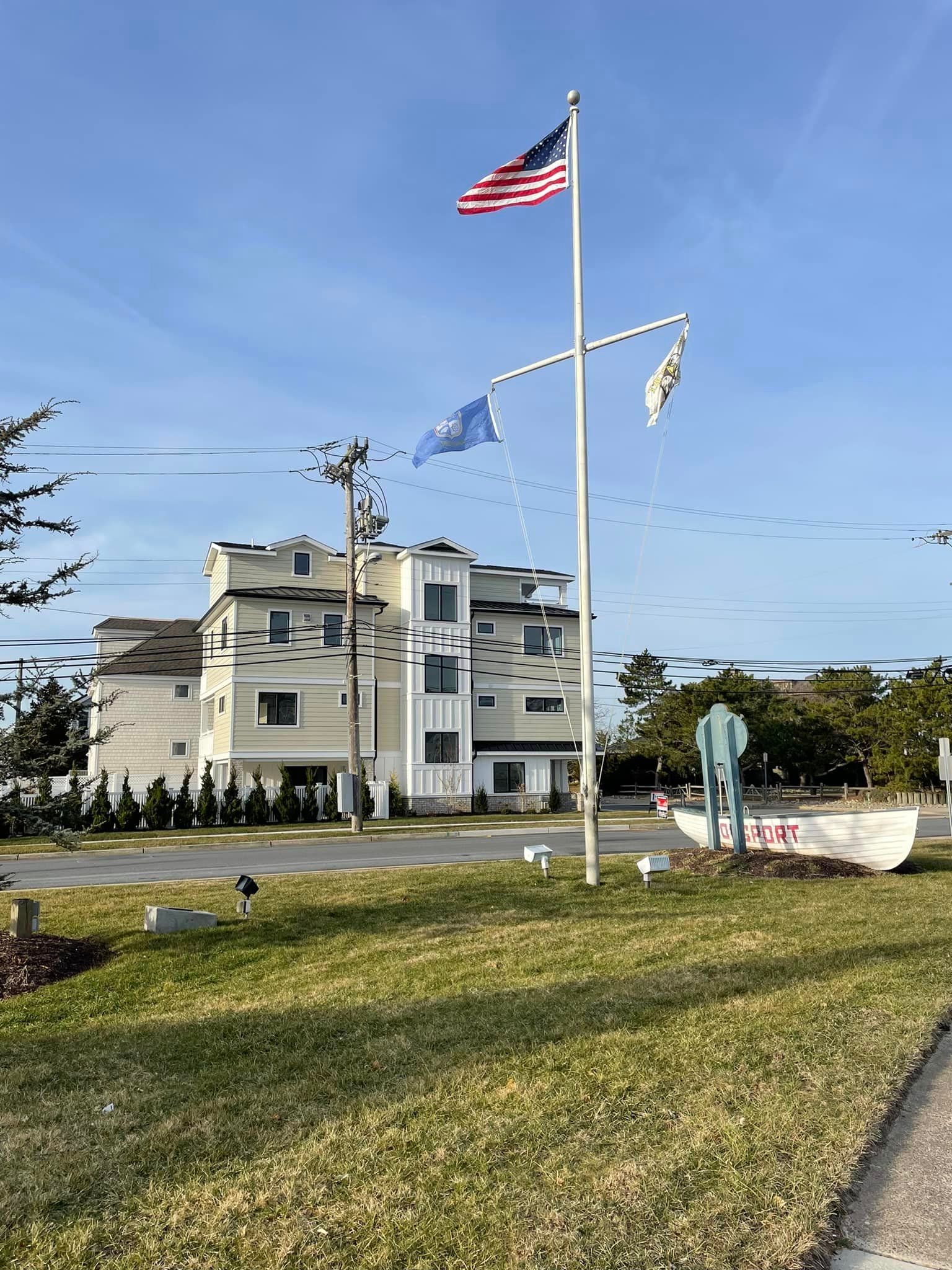 An american flag is flying on a pole in front of a building.