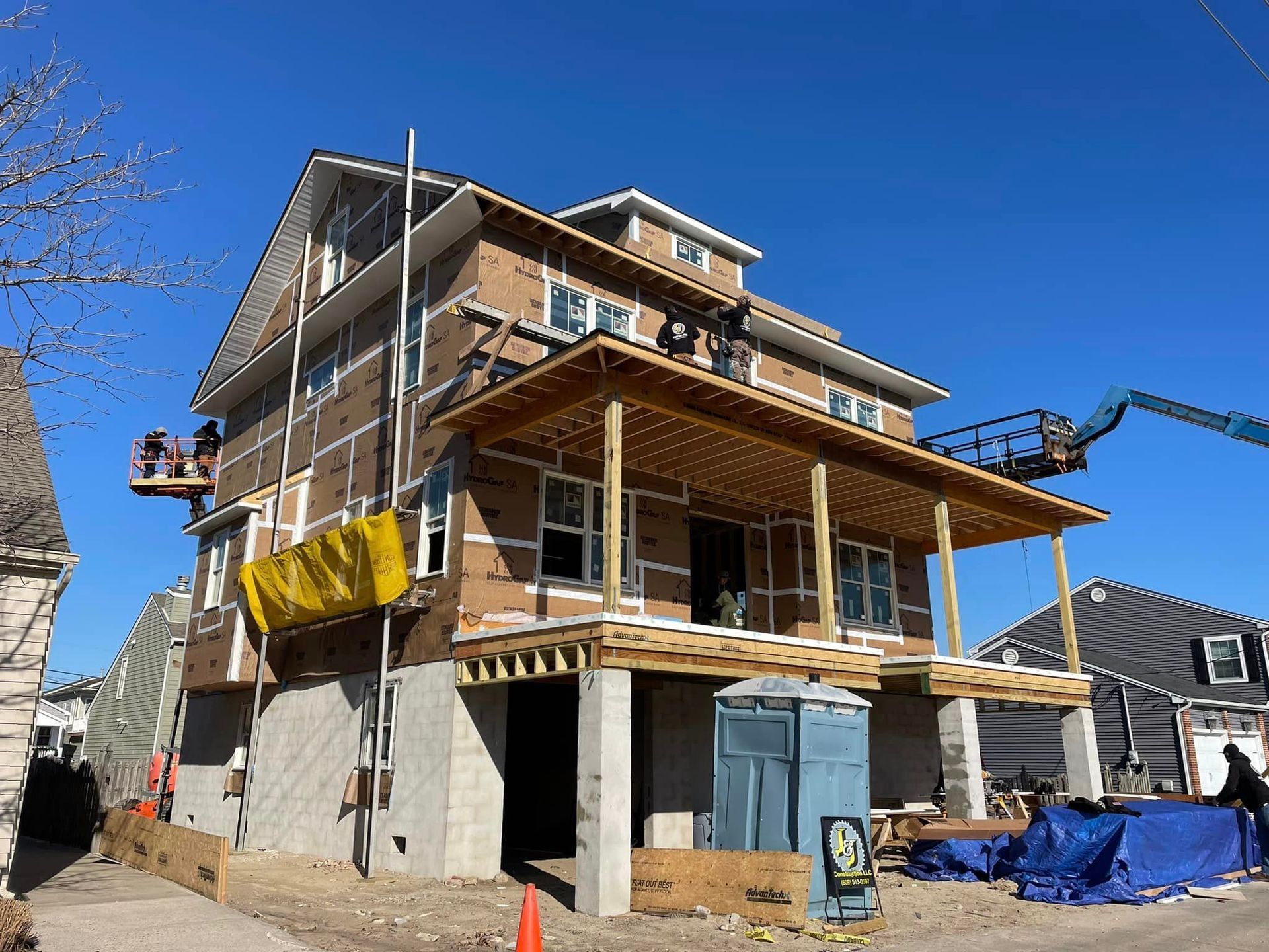 A large house is being built with a large porch.