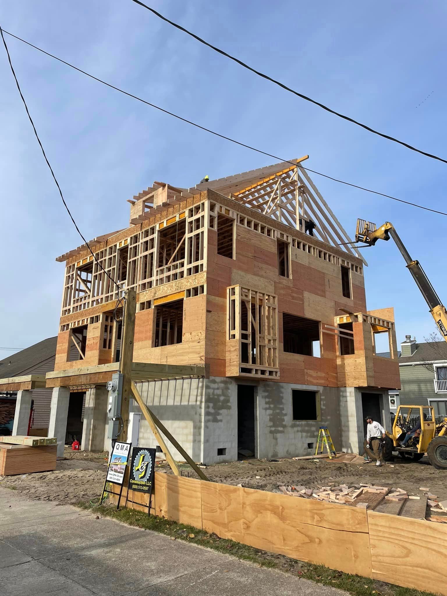 A large house is being built on the side of the road.