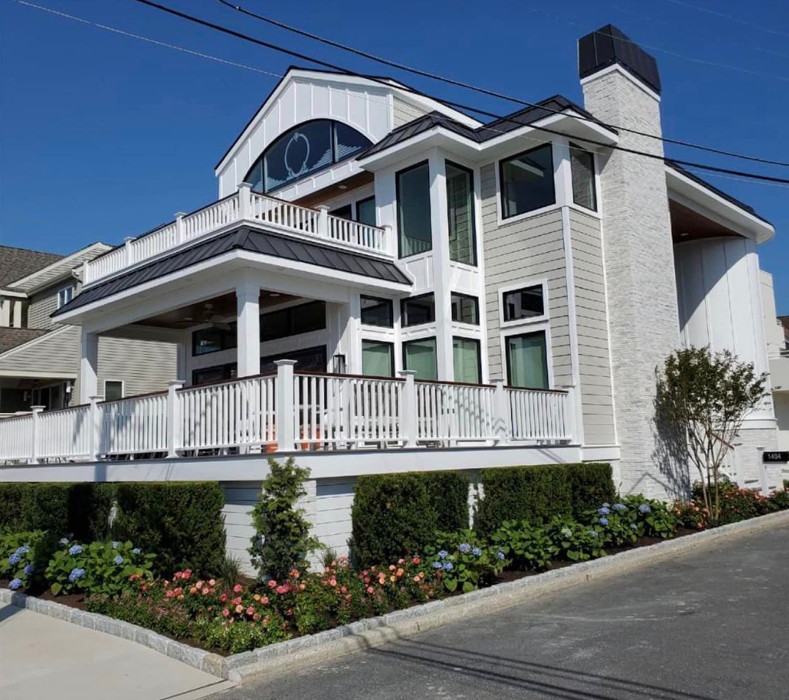 A large white house with a balcony and a chimney