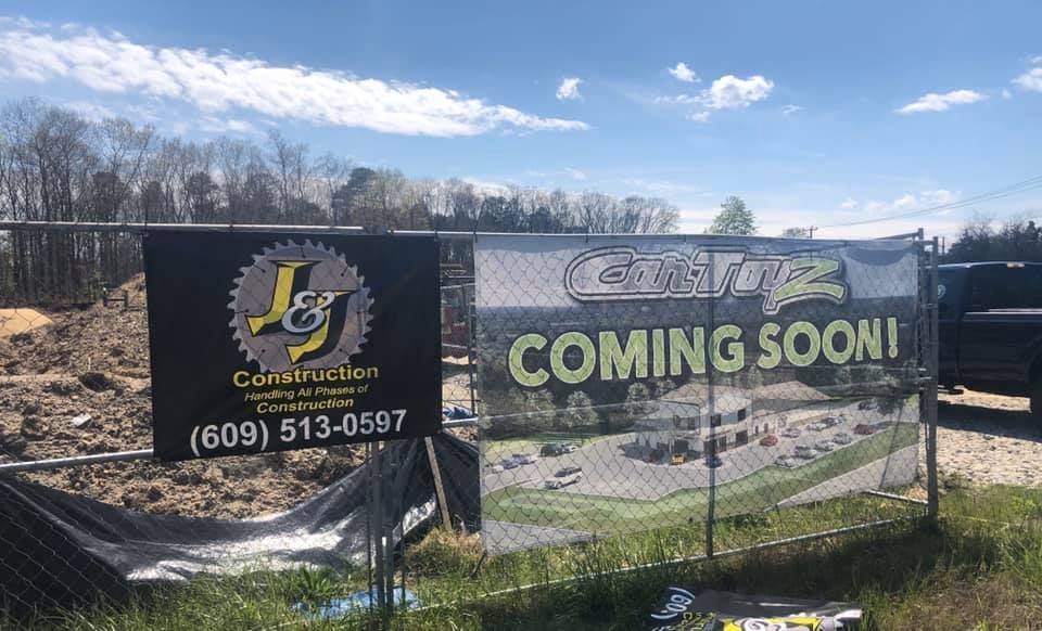 A construction site with a sign that says coming soon