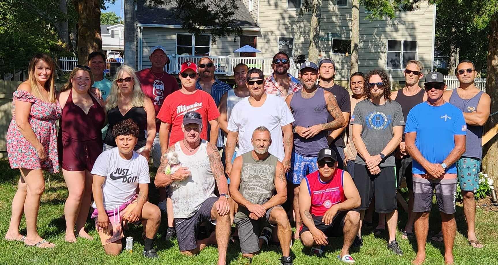 A group of people are posing for a picture in the grass.