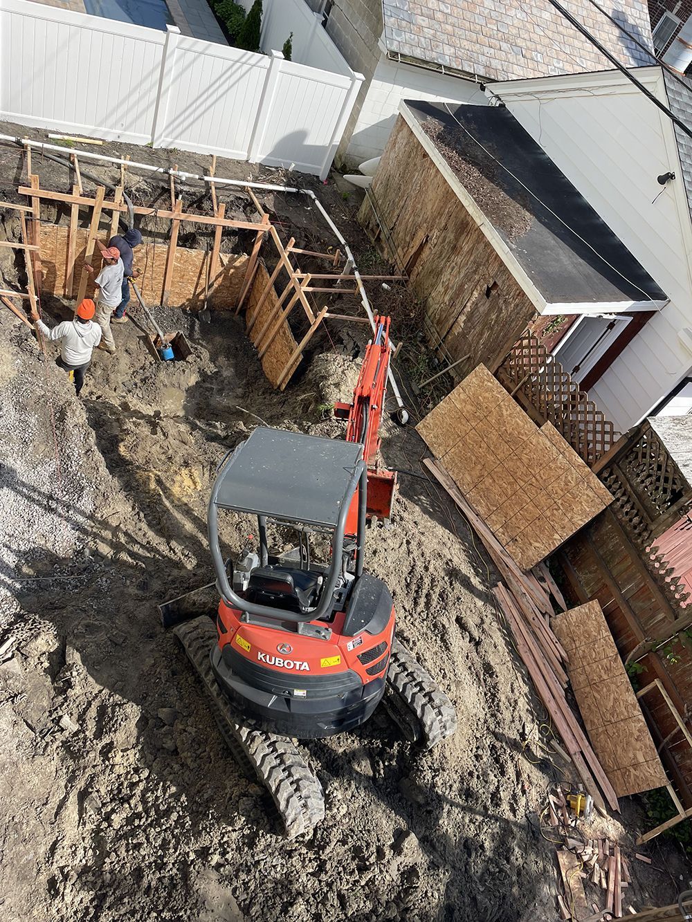 An aerial view of a construction site with a small excavator.