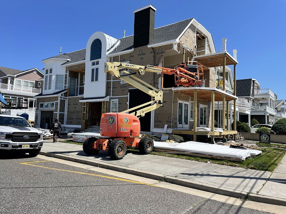 A large house is being built on a sunny day.