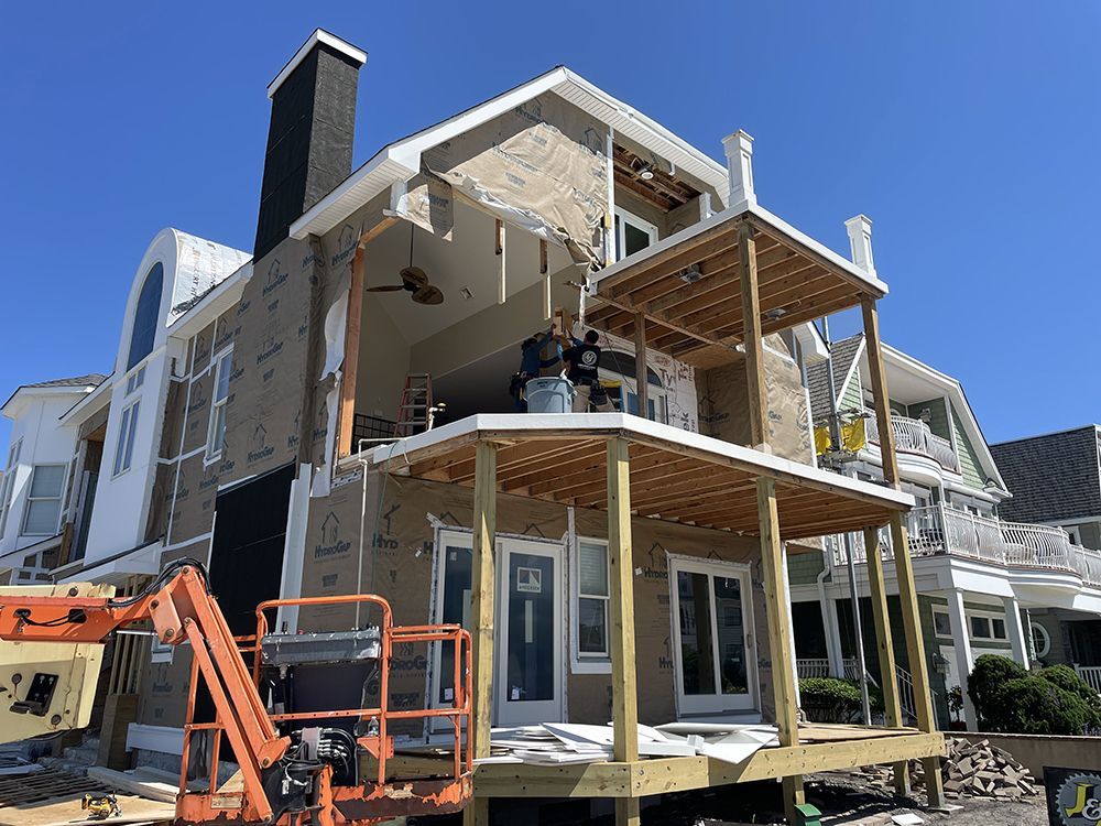 A large house is being built with a large deck.