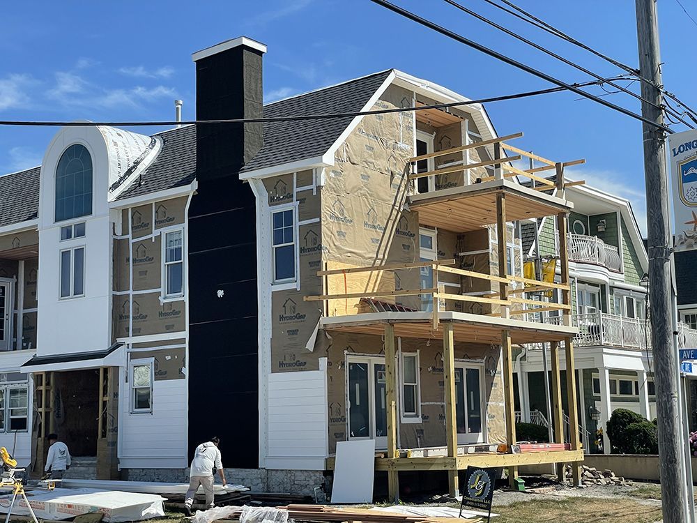 A large house is being built on a sunny day.
