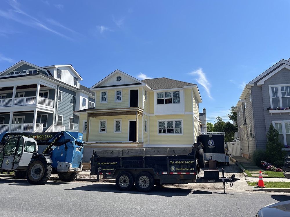 A truck is parked in front of a house under construction