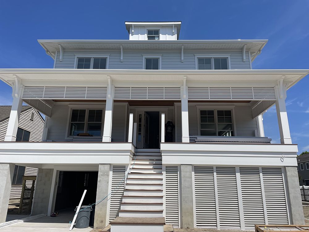 A large white house with a lot of windows and stairs