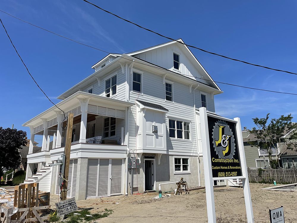 A large white house with a sign that says j on it