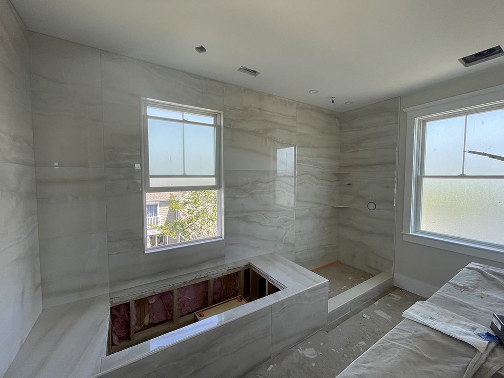A bathroom with a bathtub and a window.