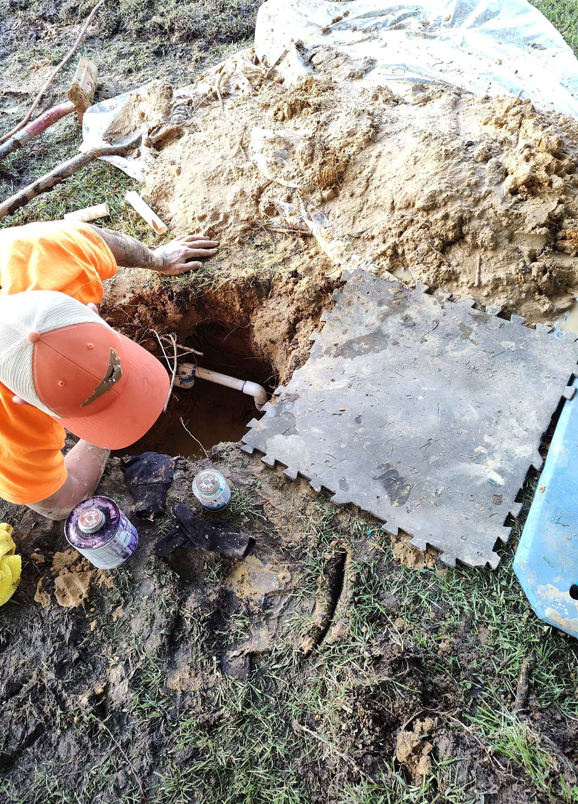 A person is digging a hole in the ground with a shovel.
