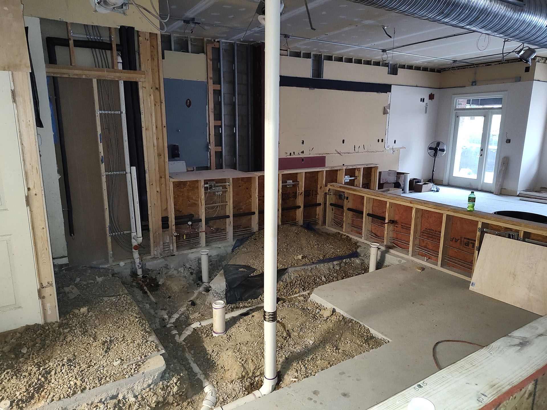 A room that is being remodeled with a lot of pipes in it