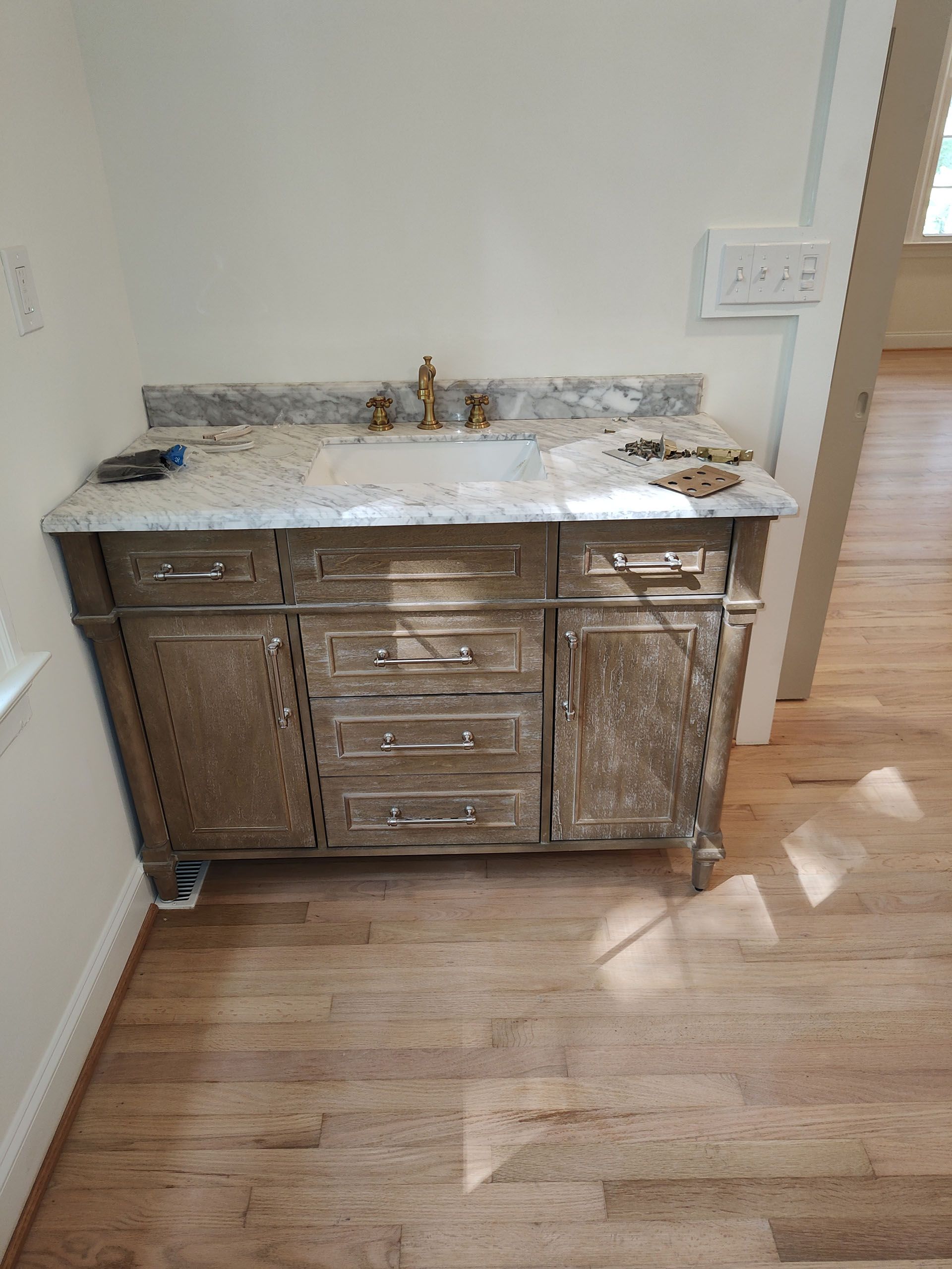 A bathroom vanity with a sink and drawers in a room.