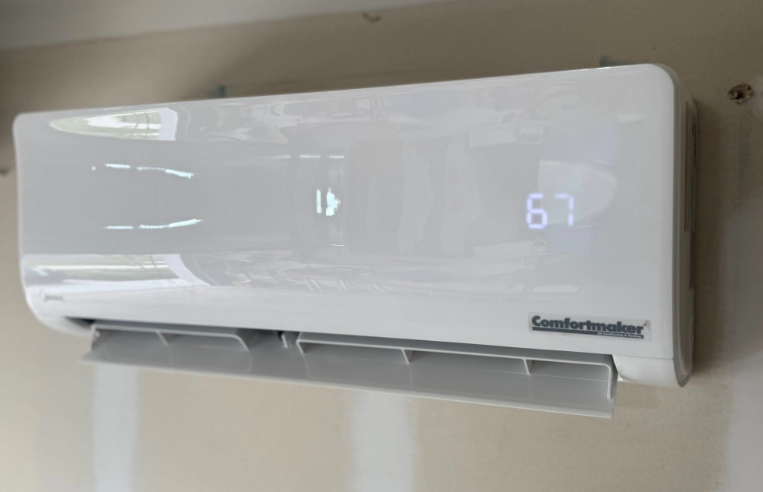 White Comfortaire mini-split air conditioner on a wall, displaying a temperature of 67.