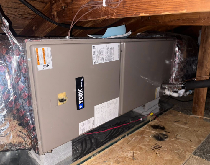York furnace installed in a wooden attic with ductwork, electrical wiring, and insulation.