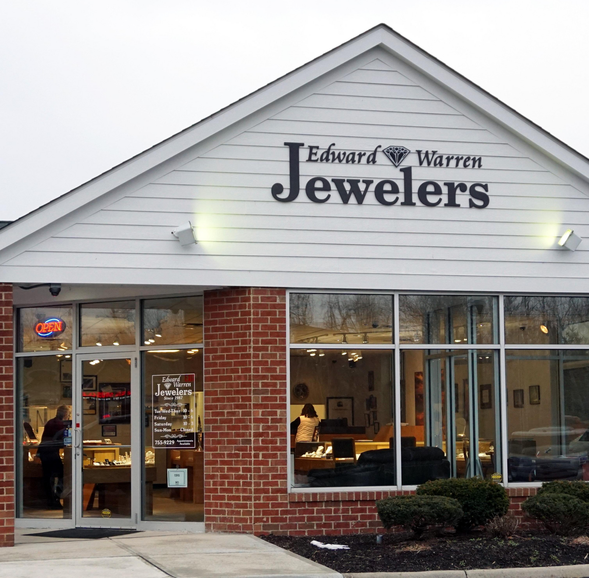 Edward Warren Jewelers storefront with brick facade and lit display windows