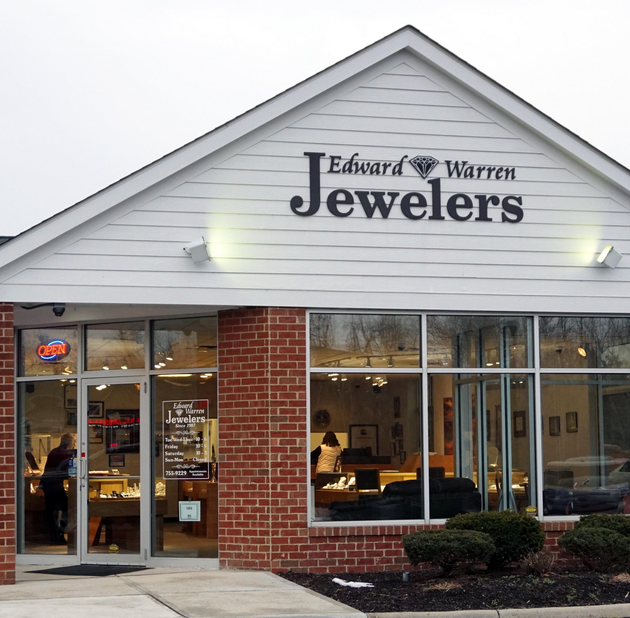 Edward Warren Jewelers storefront with brick facade and lit display windows