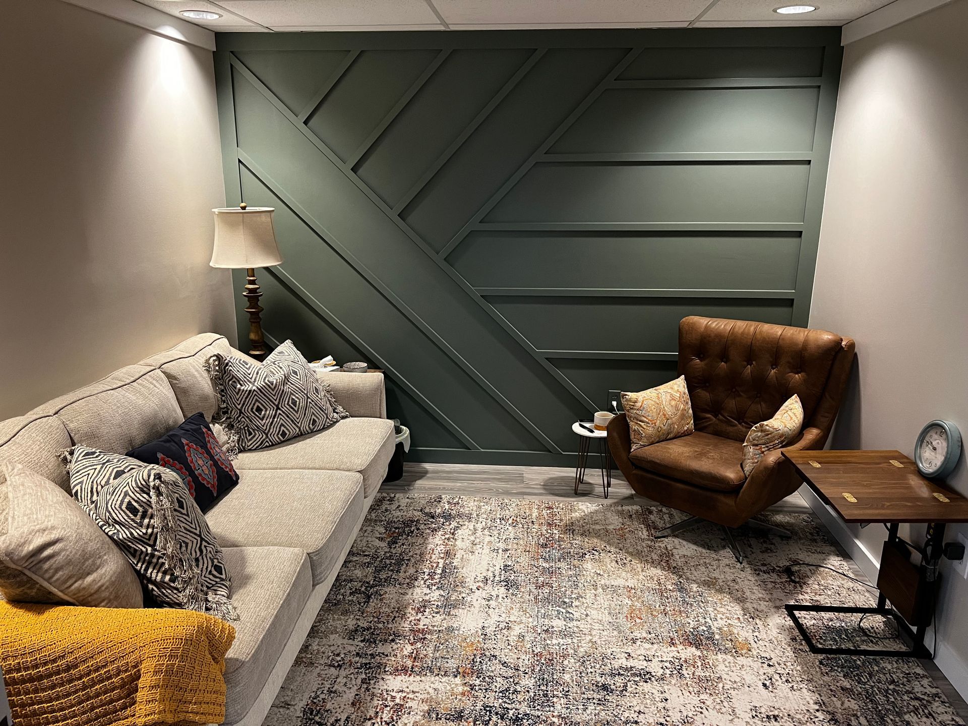 A living room with a couch , chair , table and rug.