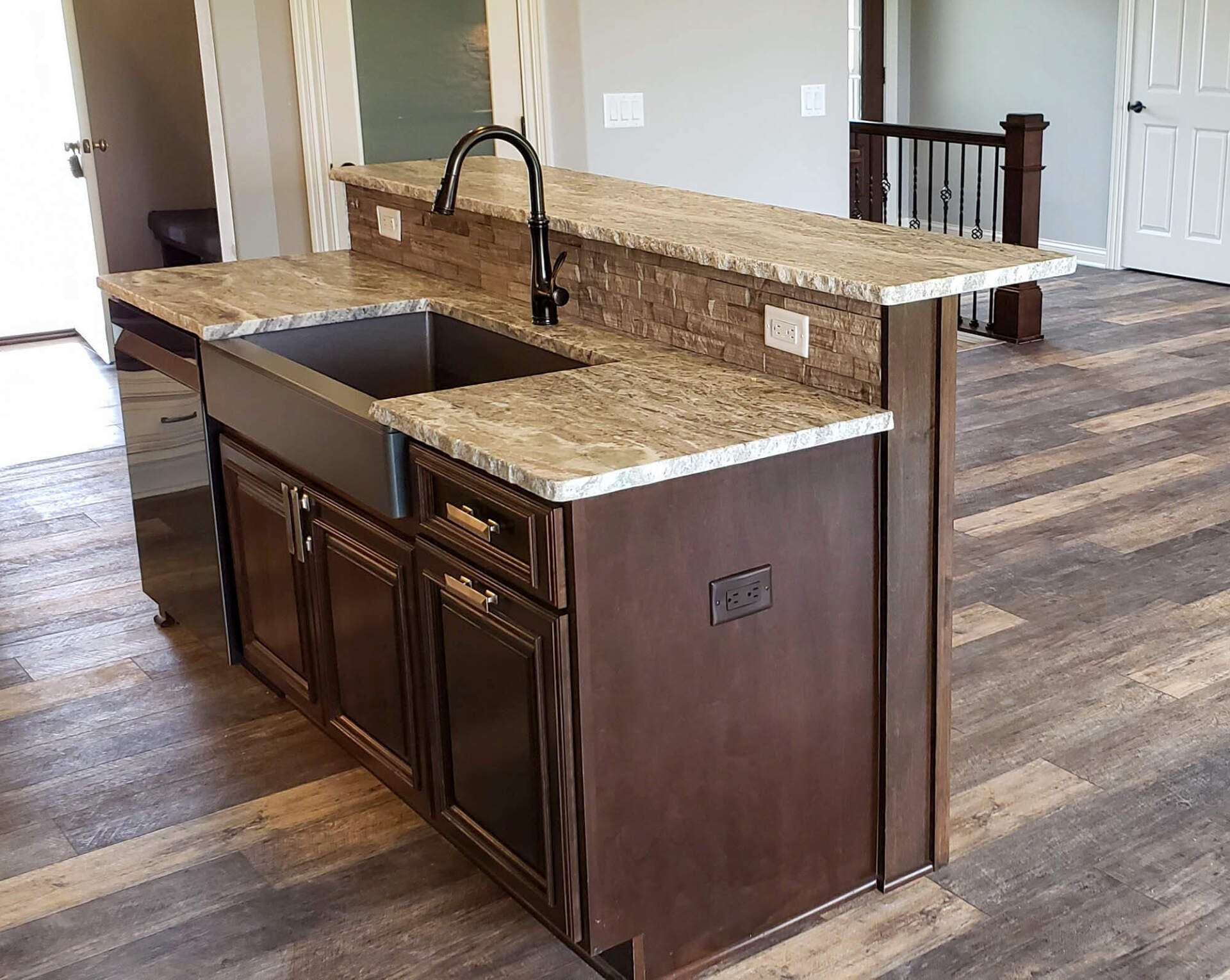 Kitchen in luxury home with wooden drawers on granite-top counter