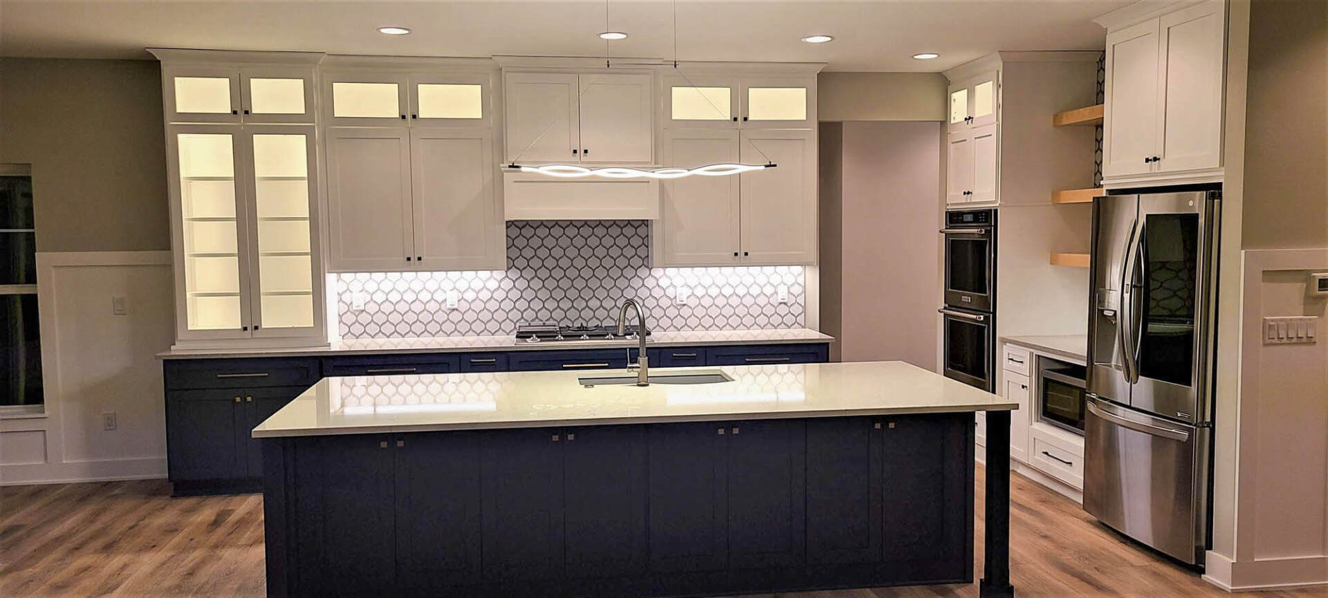 Kitchen in luxury home with wooden drawers on granite-top counter