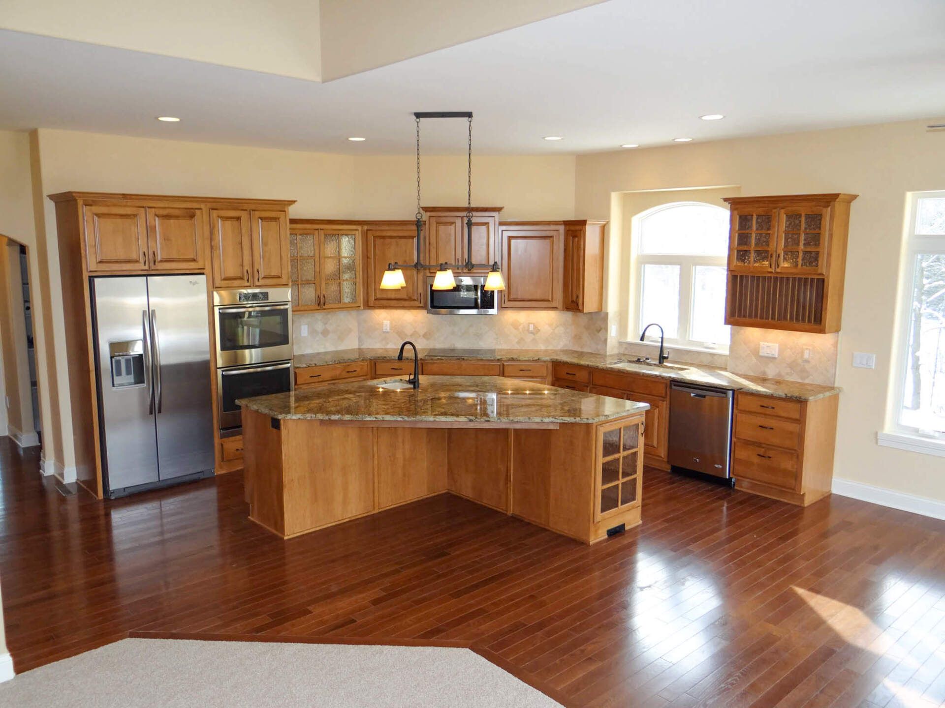 Kitchen in luxury home with wooden drawers on granite-top counter