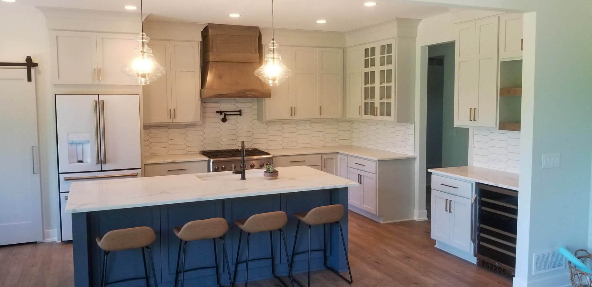 Kitchen in luxury home with wooden drawers on granite-top counter