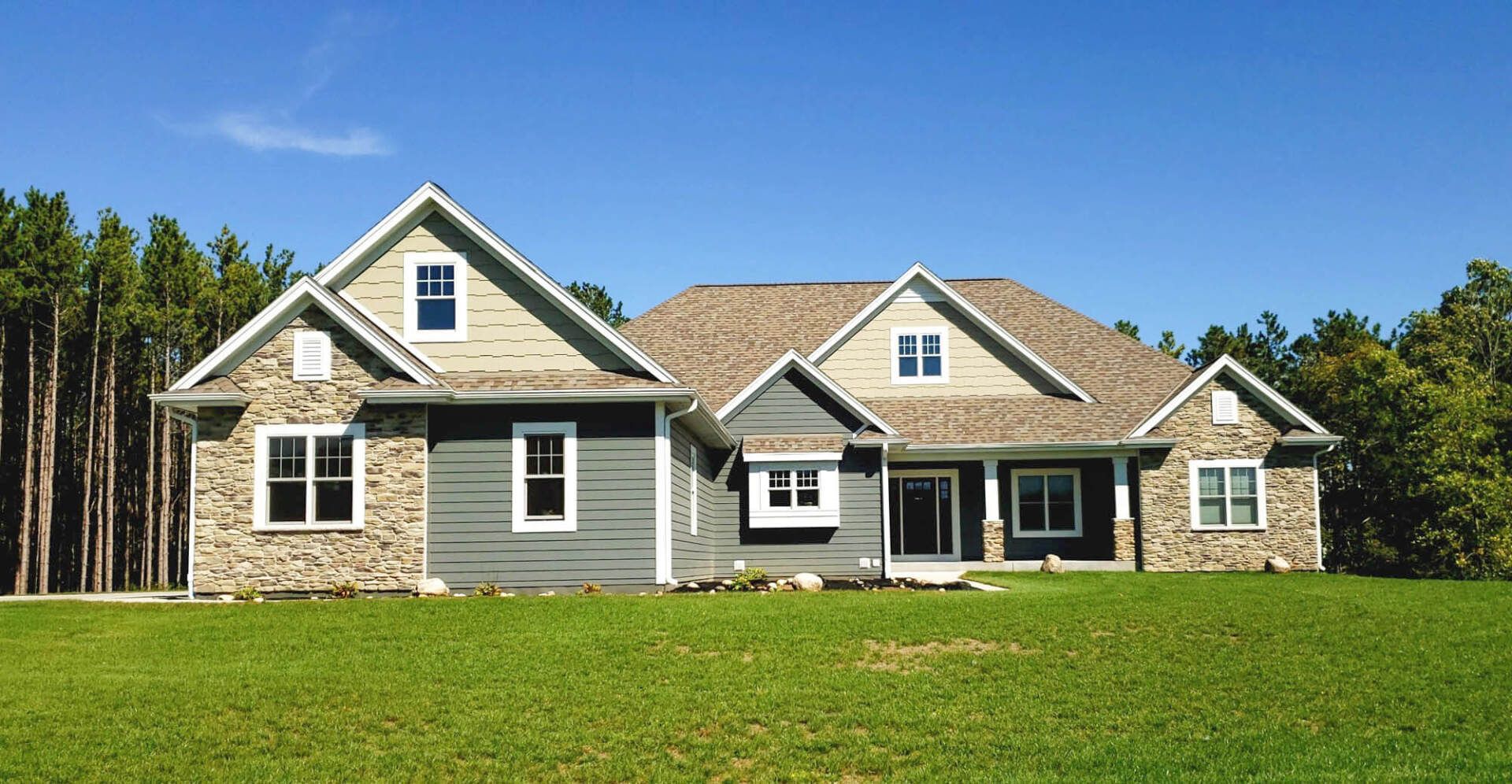 Modern luxurious zen cozy suburban house with green grass