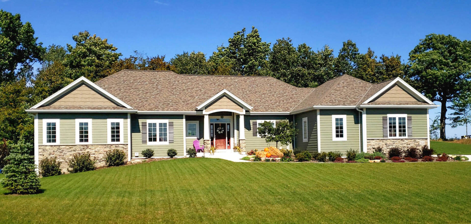 Modern luxurious zen cozy suburban house with green grass